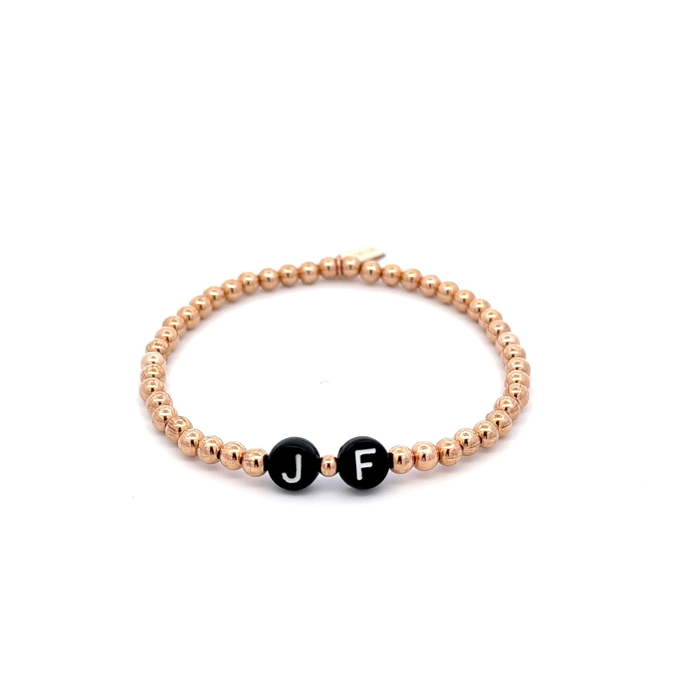 Round initials black rose-gold coloured